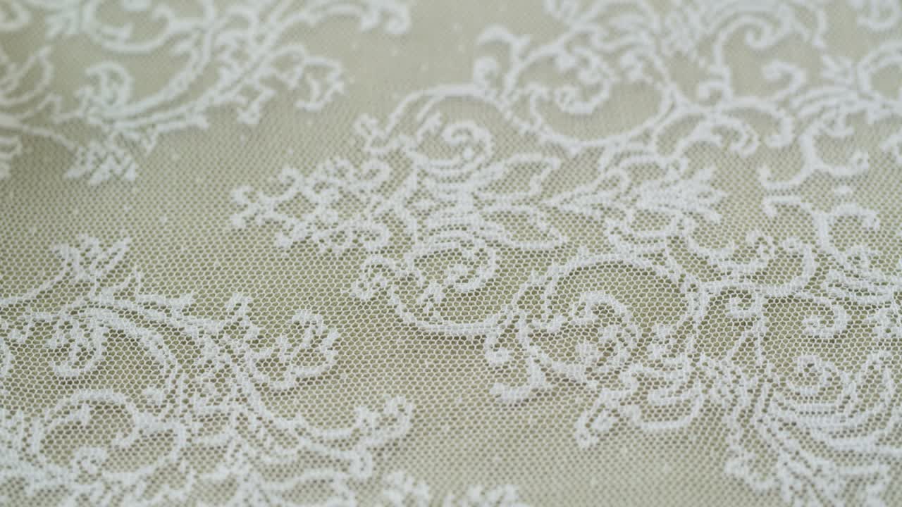 White lace close-up. Sewing a wedding dress. Light guipure. Handmade tailoring, professional clothing concept. Abstract background