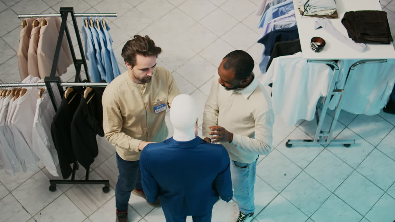 Men choosing suits in a clothing store
