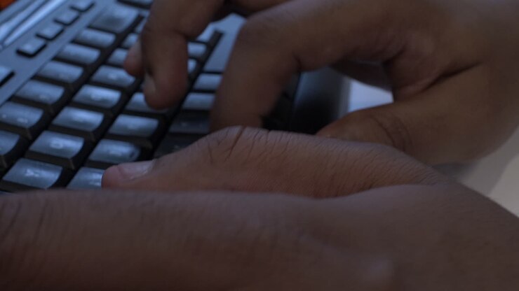 Ethnic Minority Hands Typing On Keyboard. Close Up, Low Angle