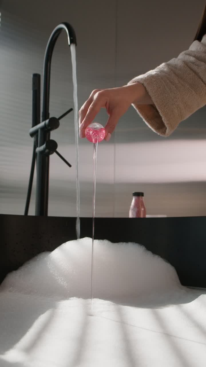 Woman pouring bubble bath
