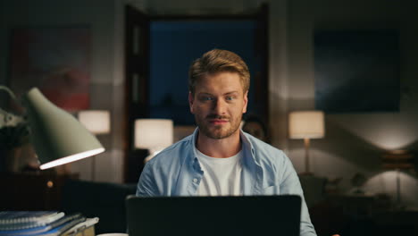 focused man speaking computer cozy home. housewife silhouette sitting background
