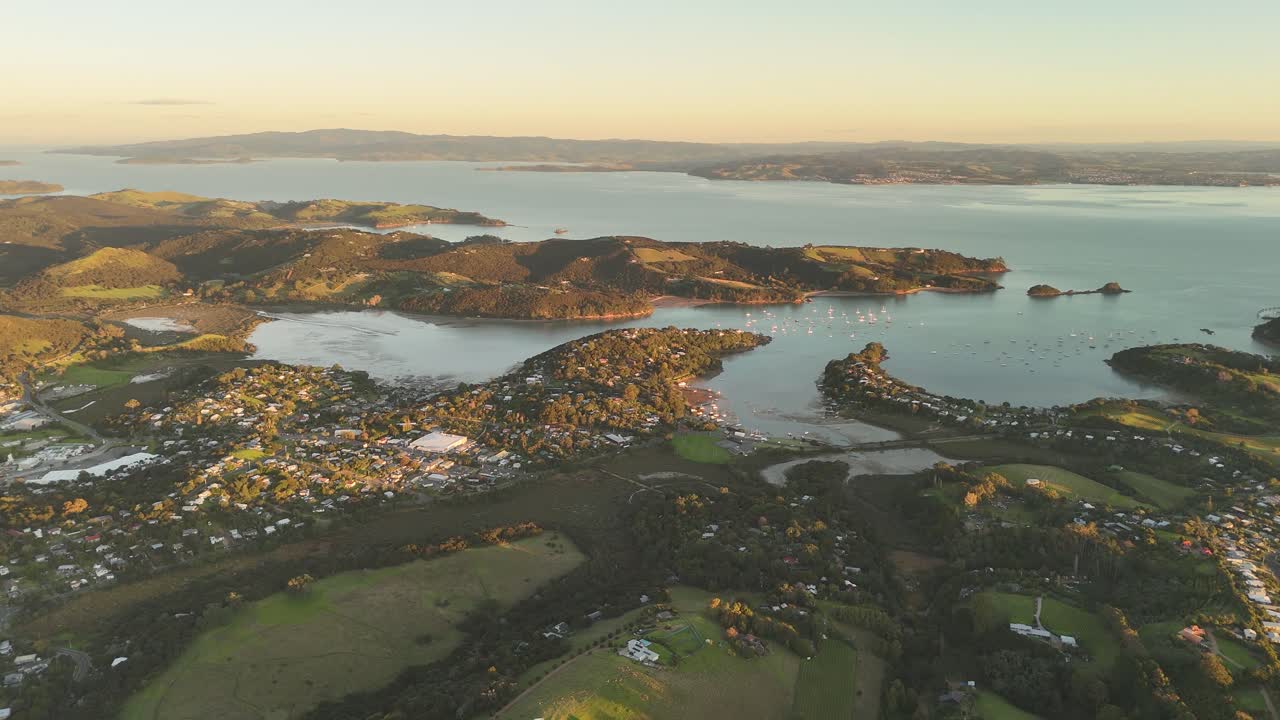 High altitude aerial view of Waiheke Island at sunset over the coastline.