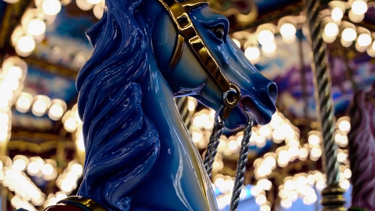 Blue Carousel Horse Rotating at Night with Bokeh Lights