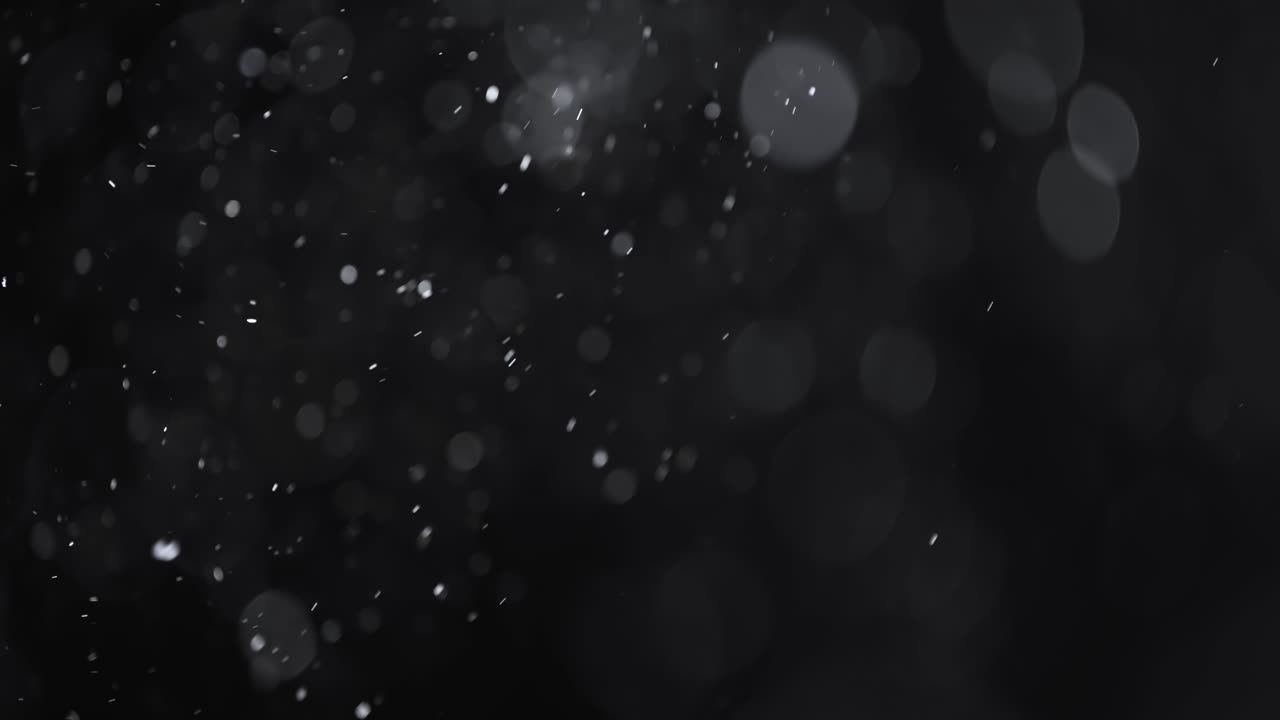 어두운 배경에 떠 있는 추상 입자 보케