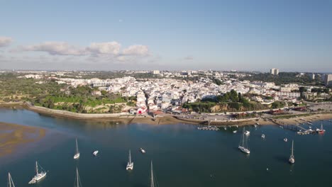 Beautiful-Mediterranean-city-Alvor-in-Portugal,-Algarve-coast,-aerial-orbit