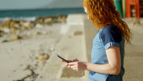 Woman-taking-photo-with-mobile-phone-at-beach-4k