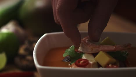 video of chef decorating the dish with shrimp before serving