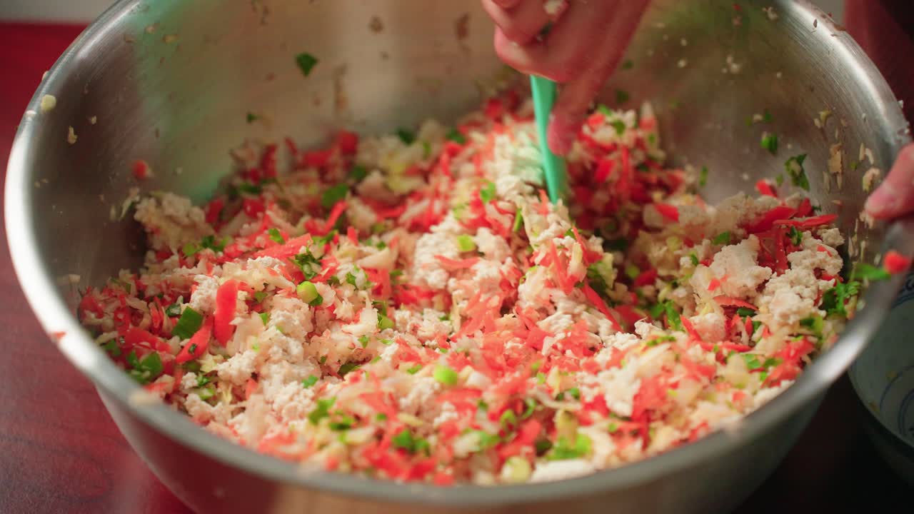 Mixing vegetable filling in large bowl