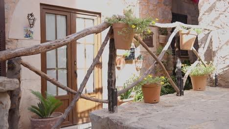 Beautiful-women-going-down-a-small-sidewalk-on-a-sunny-day-in-valldemossa,-highest-village-at-mallorca