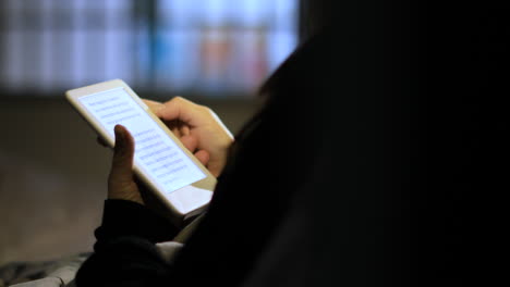 adult woman reads from an amazon kindle e-reader