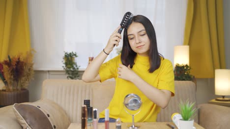 Young-woman-combing-her-hair.-Hair-care.