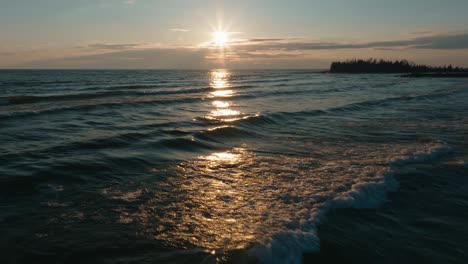 Puesta-De-Sol-Sobre-Owen-Sound-Con-Olas-Rompiendo-Suavemente-En-La-Orilla,-Iluminación-De-Hora-Dorada