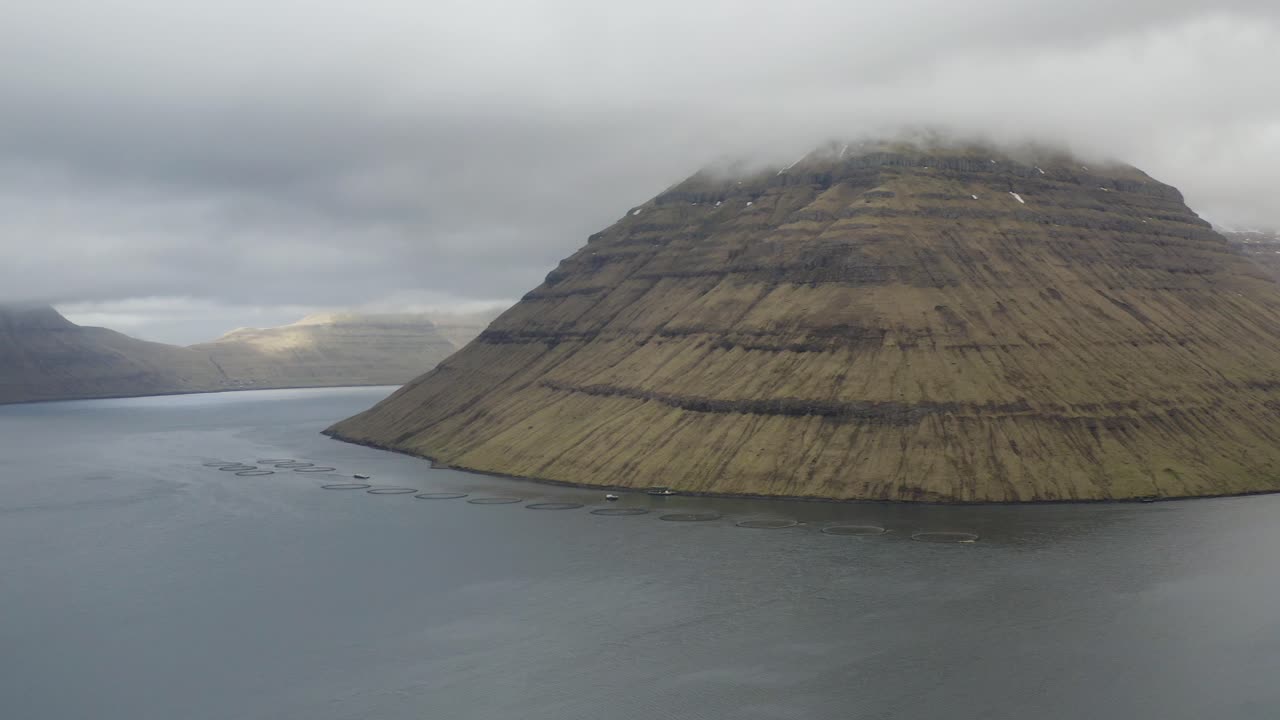 Aerial panning shot of Bor&eth;oy island with view to Kunoy and Kalsoy and Klaksvik town