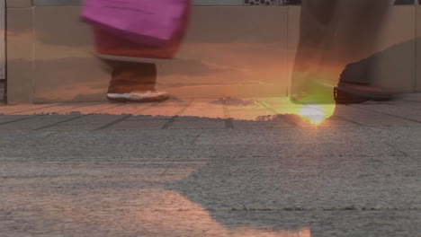 composite video of sunset sky against low section of people walking