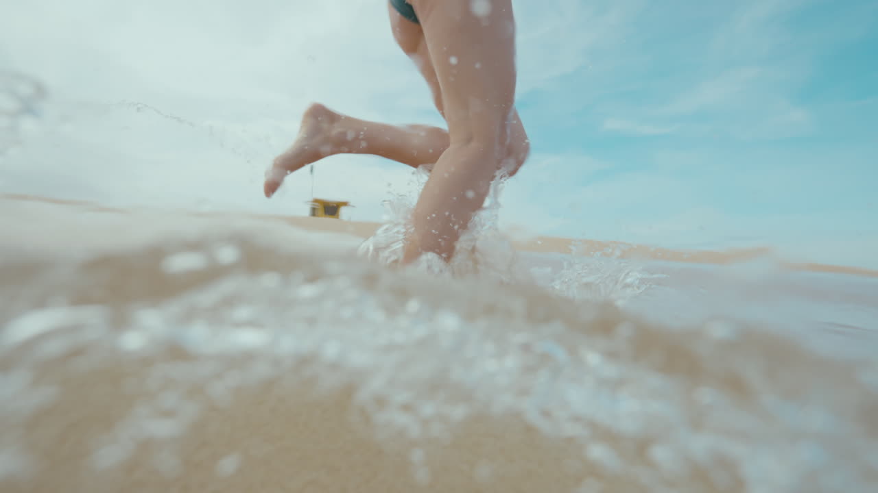 Woman Running Through Ocean Waves