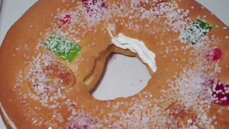 roscon de reyes with cream, typical spanish christmas pastry, overhead pan left