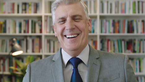 close up portrait of serious caucasian businessman boss laughing cheerful enjoying corporate lifestyle wearing suit in library study office