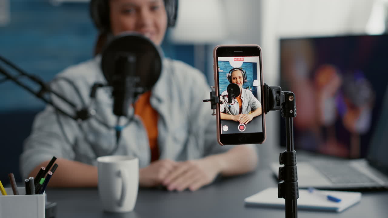 Popular social media influencer recording daily vlog with smartphone while telling stories