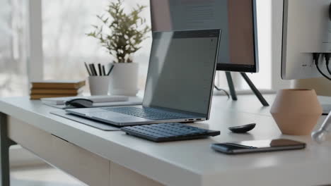 modern home office desk setup with laptop and monitor