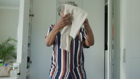 african american senior woman packing suitcase for travel