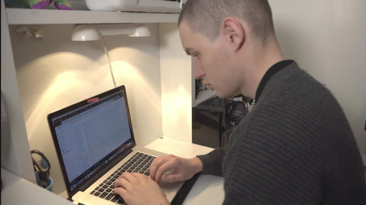 A Young Man Is Busy On Scrolling And Browsing On Laptop.- closeup shot