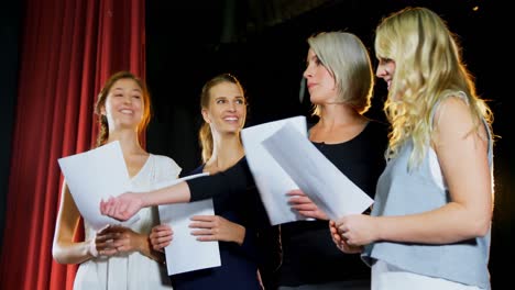 Actors-reading-their-script-on-stage-4k