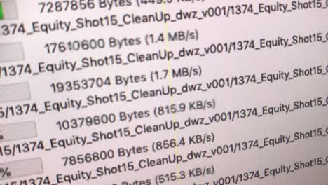 handheld super close shot of monitor showing growing upload bars, file names and percentages of a ftp program in german language