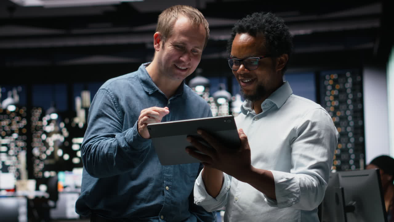 Two Diverse Businessmen Collaborating on a Digital Tablet in a Modern Office