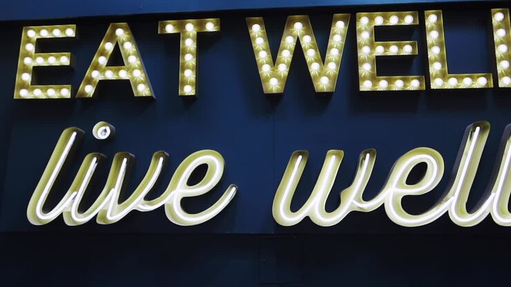 Healthy lifestyle message Eat Well Live Well on a blue background