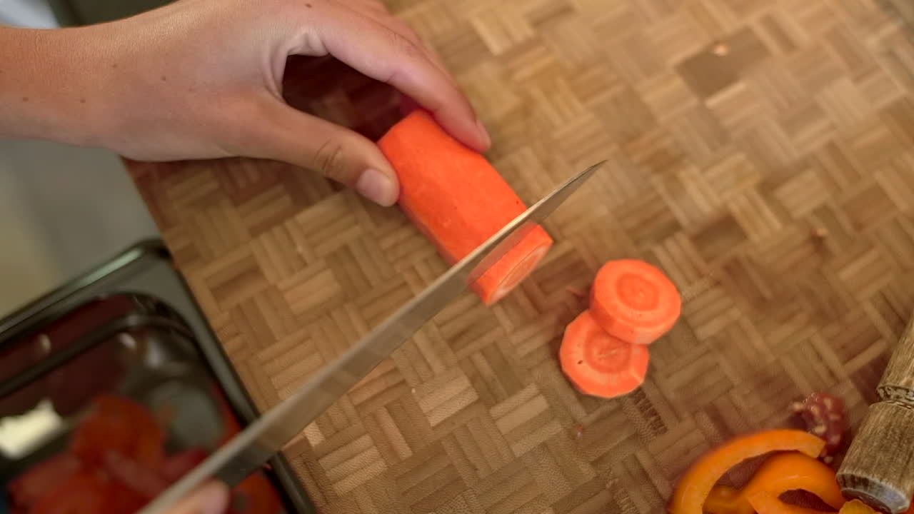 Close Up of Female Hands Slicing a Carrot