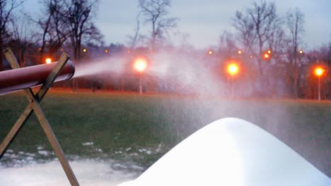 snow cannon makes artificial snow at night