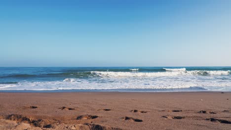 clean and clear beach with a clear blue sky at 60fps