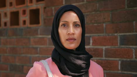 young woman wearing hijab out and about in the city