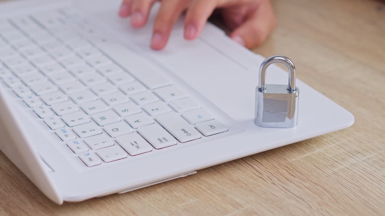 Cyber security concept silver padlock locking white computer keyboard