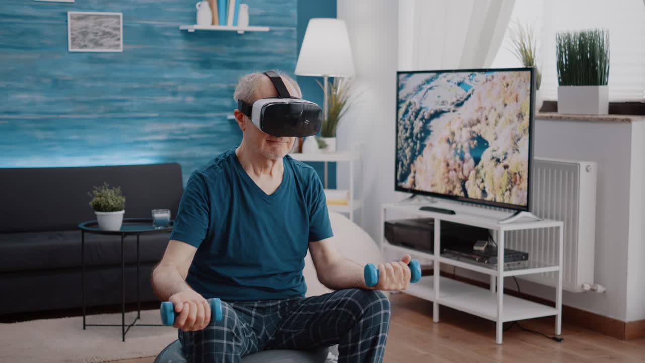Pensioner using vr glasses to do physical exercise with dumbbells