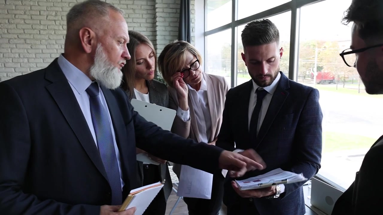 Diverse Business Team Discussing Documents and Collaborating in Modern Office