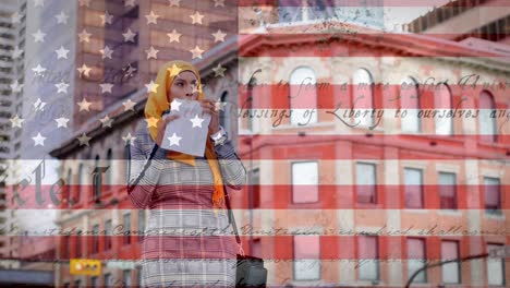 animation of american flag waving over mixed race woman in hijab