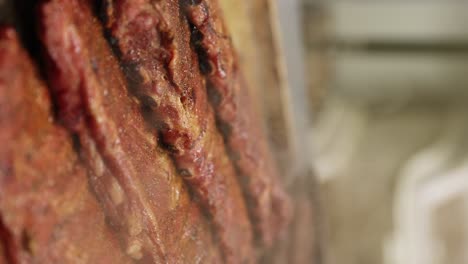 vertical - smoked barbecue beef ribs cooking on grill