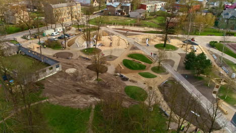 aerial drone rotating shot over kids playground under construction in city park at daytime