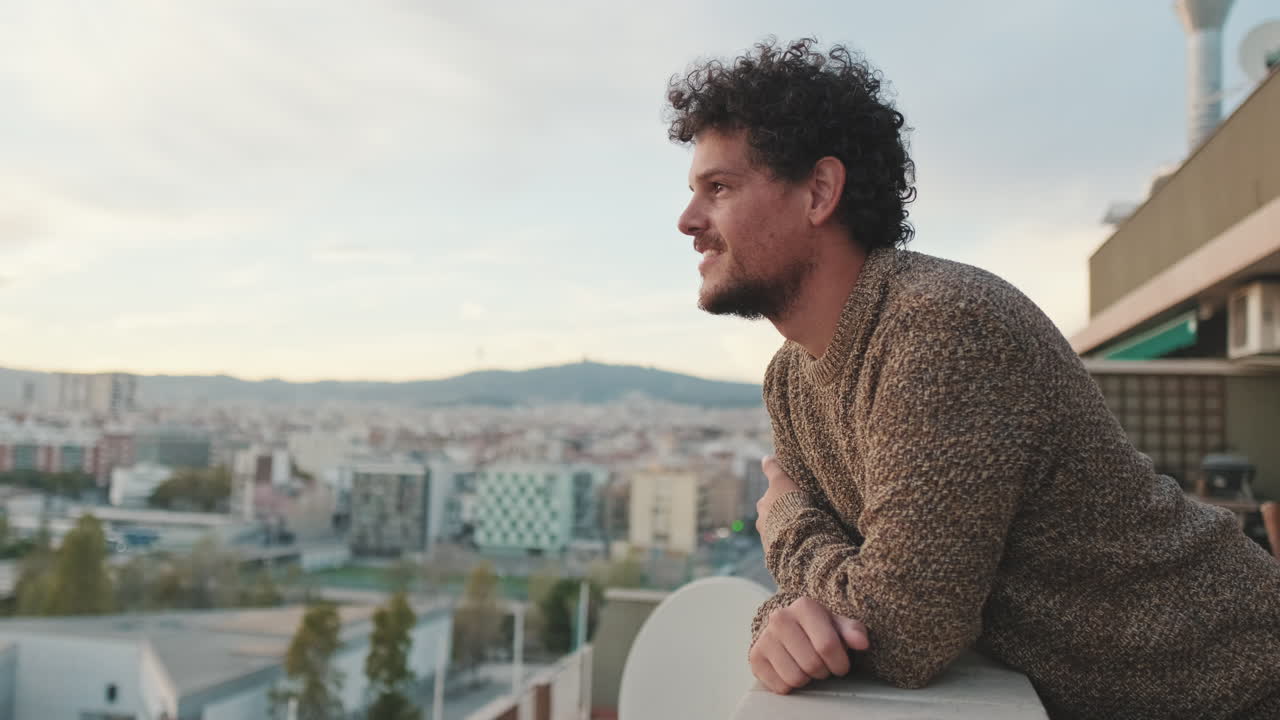 Man on a balcony overlooking the city