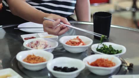 person arranging multiple dishes on a table