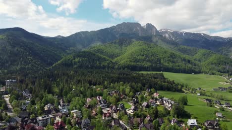 landscape fly by of the legendary giewont peak in the polish tatry mountains, farmland, forests near zakopane, poland, a resort town with traditional goral architecture-5