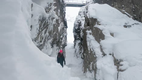 girl standing in a big rocky cave in björkliden, sweden