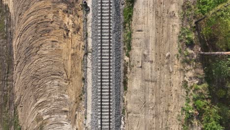 the drone shot shows a railway line from directly above