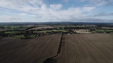 daytime drone flight over irish fields which have been harvested