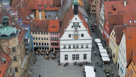 4k aerial drone video of the historic clock tower on the market square of rothenburg, germany