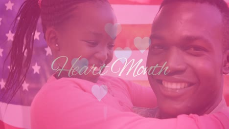 animation of heart month text hearts over african american man and his daughter on flag of usa