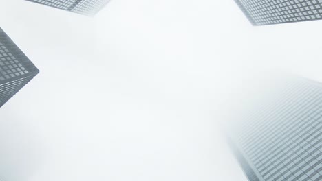 zooming up buildings on a cloudy day with fog