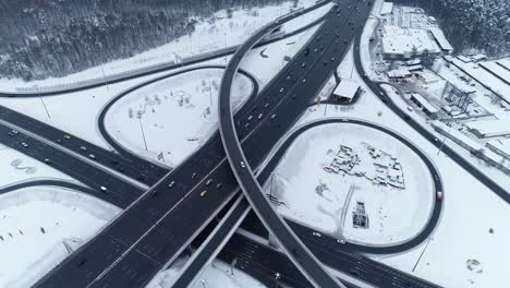 aerial view of a freeway intersection snow-covered in winter.