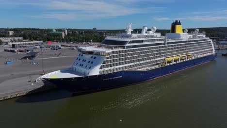 saga cruise ship spirit of adventure alongside in port. turku castle in background. low altitude aerial side view.